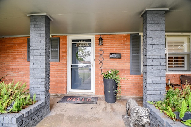 5521 Rosewood Dr, Galveston, TX 77551 - doorway to property featuring covered porch and brick siding