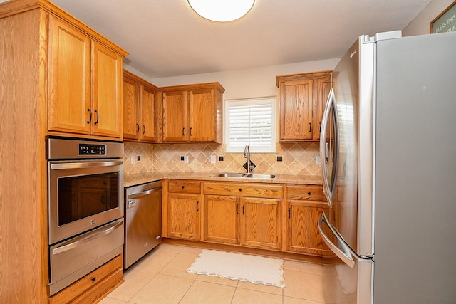 5521 Rosewood Dr, Galveston, TX 77551 - kitchen featuring a sink, a warming drawer, appliances with stainless steel finishes, and decorative backsplash
