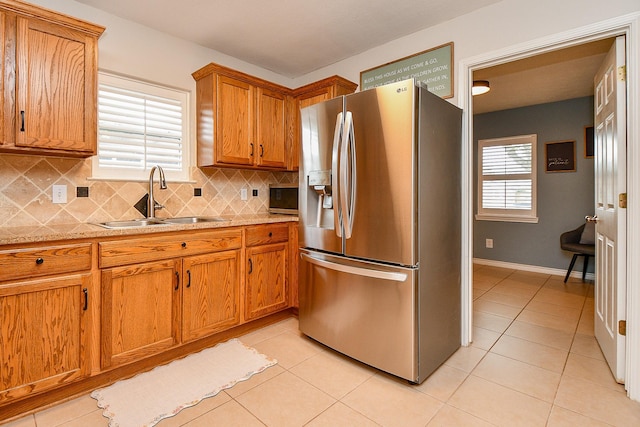 5521 Rosewood Dr, Galveston, TX 77551 - kitchen featuring light countertops, a sink, stainless steel appliances, and a wealth of natural light