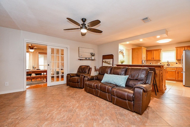 5521 Rosewood Dr, Galveston, TX 77551 - living room with french doors, visible vents, baseboards, and ceiling fan