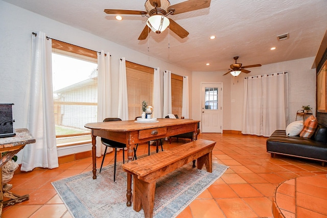 5521 Rosewood Dr, Galveston, TX 77551 - dining room with ceiling fan, visible vents, a healthy amount of sunlight, and light tile patterned floors