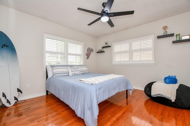 5521 Rosewood Dr, Galveston, TX 77551 - bedroom with baseboards, wood finished floors, and a ceiling fan