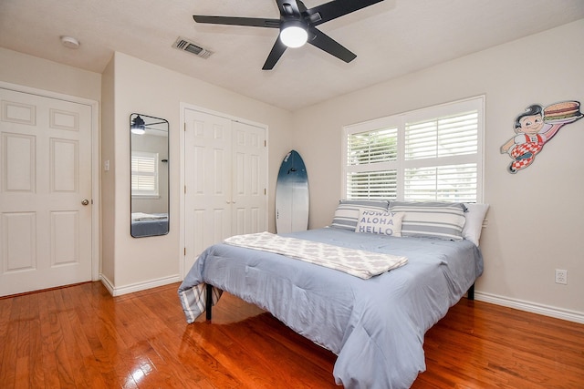 5521 Rosewood Dr, Galveston, TX 77551 - bedroom with a closet, baseboards, visible vents, and wood finished floors