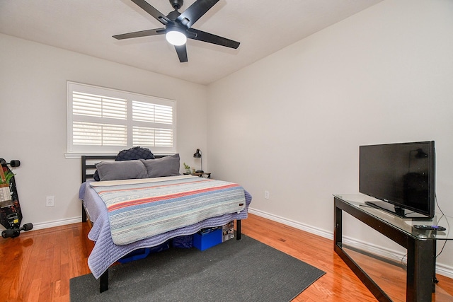 5521 Rosewood Dr, Galveston, TX 77551 - bedroom featuring baseboards, wood finished floors, and ceiling fan
