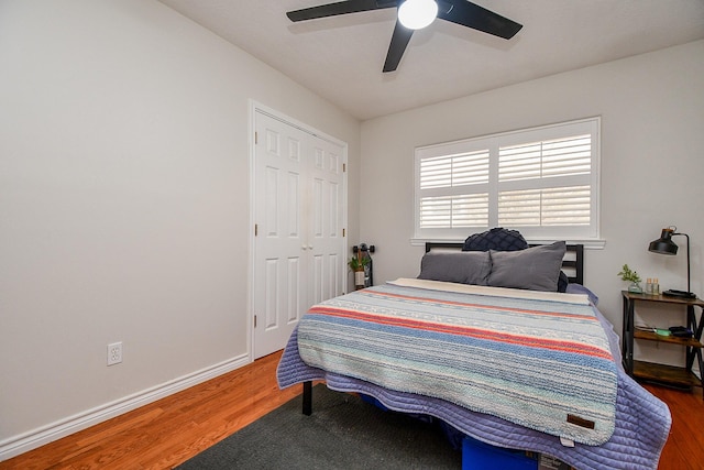 5521 Rosewood Dr, Galveston, TX 77551 - bedroom with baseboards, wood finished floors, a closet, and a ceiling fan