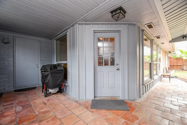 5521 Rosewood Dr, Galveston, TX 77551 - doorway to property with a patio and board and batten siding