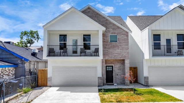 view of front of property with driveway, fence, board and batten siding, a balcony, and a garage