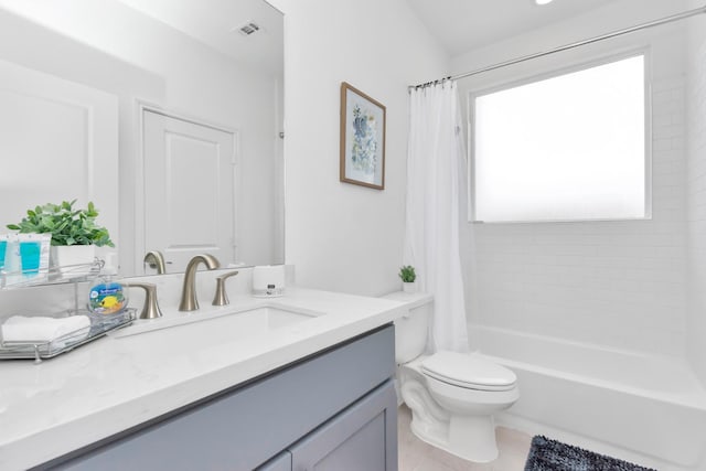 bathroom with toilet, vanity, shower / bath combo with shower curtain, and visible vents