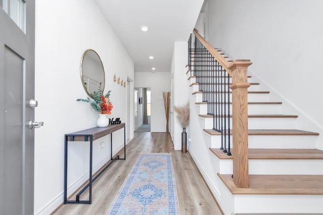 entrance foyer featuring baseboards, recessed lighting, wood finished floors, and stairway