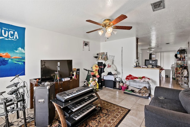 1520 Hillside Dr, College Station, TX 77845 - living area featuring a textured ceiling, visible vents, ceiling fan, and light tile patterned floors