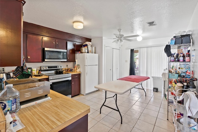 1520 Hillside Dr, College Station, TX 77845 - kitchen with stainless steel appliances, light countertops, visible vents, light tile patterned floors, and a textured ceiling