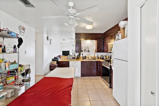 1520 Hillside Dr, College Station, TX 77845 - kitchen with a sink, visible vents, a ceiling fan, white appliances, and light countertops