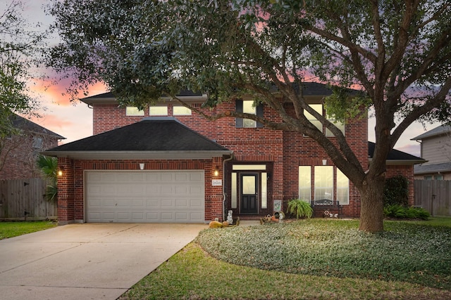traditional-style home featuring a garage, brick siding, and concrete driveway