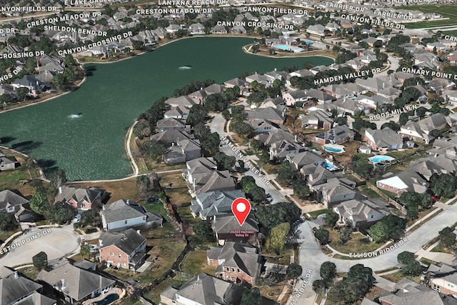 aerial overview of property's location featuring nearby suburban area and a large body of water
