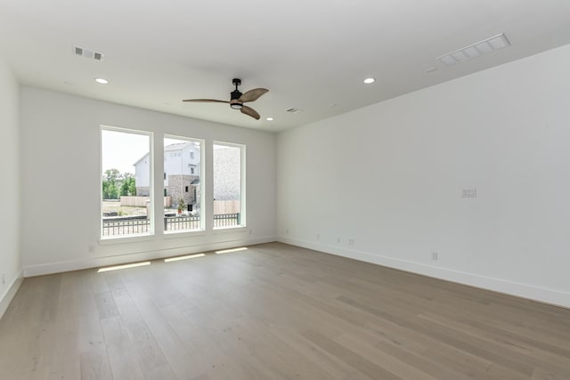 spare room featuring visible vents, light wood-style floors, recessed lighting, and a ceiling fan