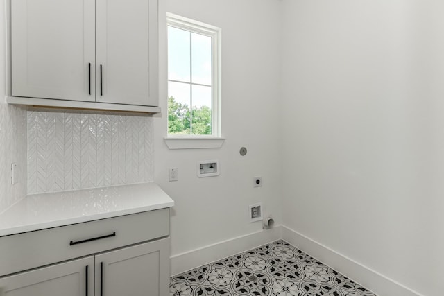laundry room featuring hookup for an electric dryer, light tile patterned floors, hookup for a washing machine, baseboards, and cabinet space