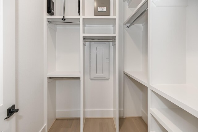walk in closet featuring light wood-style flooring