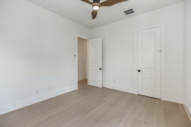 unfurnished bedroom with baseboards, a ceiling fan, visible vents, and light wood-type flooring