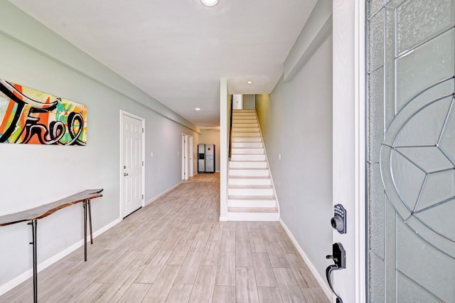 9605 Teichman Rd, Galveston, TX 77554 - foyer featuring light wood-type flooring, recessed lighting, baseboards, and stairway