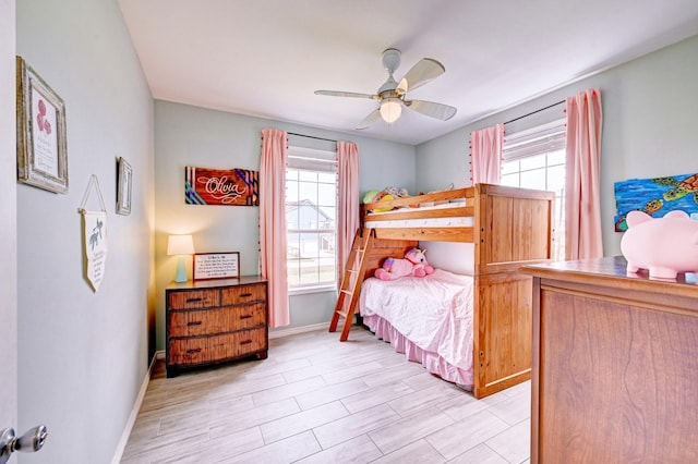 9605 Teichman Rd, Galveston, TX 77554 - bedroom featuring baseboards and a ceiling fan
