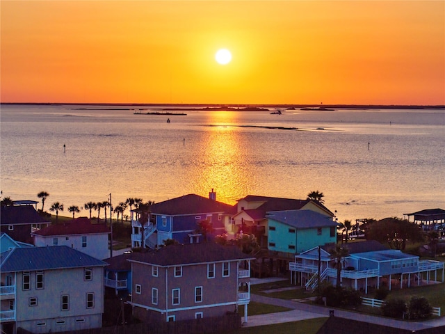 9605 Teichman Rd, Galveston, TX 77554 - aerial view at dusk with a water view, a residential view, and a view of the beach