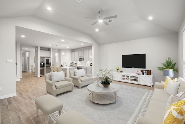 12018 Maple Oak Dr, Houston, TX 77066 - living area featuring vaulted ceiling, light wood-style floors, a ceiling fan, and recessed lighting