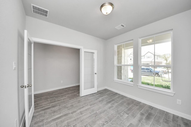 12018 Maple Oak Dr, Houston, TX 77066 - unfurnished room featuring french doors and wood finished floors
