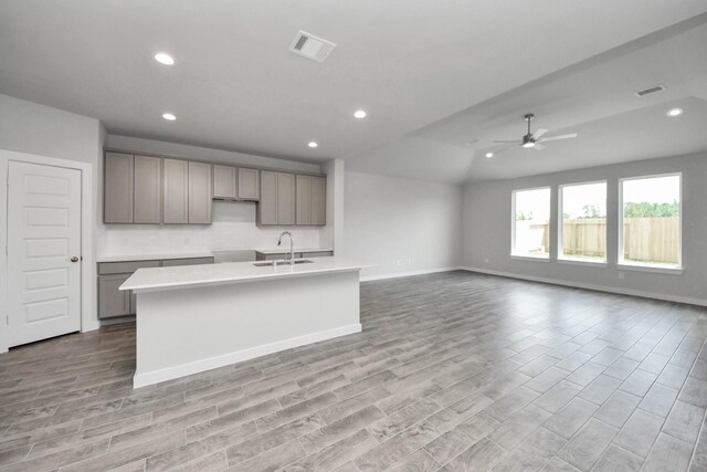 12018 Maple Oak Dr, Houston, TX 77066 - kitchen with gray cabinets, recessed lighting, light wood-type flooring, a ceiling fan, and a center island with sink