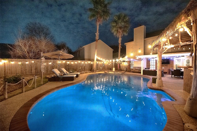 view of pool with a fenced backyard, a patio, a pool with connected hot tub, and outdoor lounge area