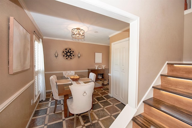 dining room featuring ornamental molding and stairs