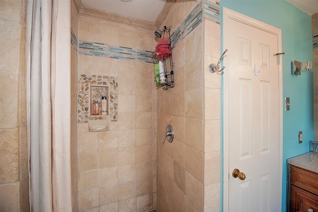 bathroom with a stall shower, vanity, and ornamental molding