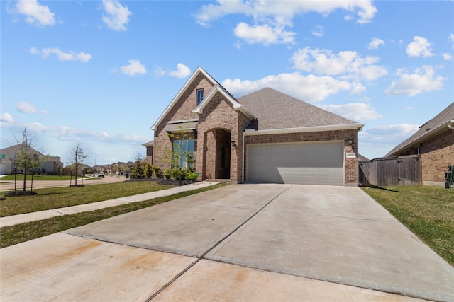 4831 Dove Cove Ln, League City, TX 77573 - view of front of house with an attached garage, brick siding, a front lawn, and concrete driveway