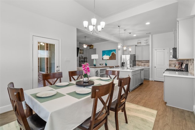 4831 Dove Cove Ln, League City, TX 77573 - dining area featuring recessed lighting, ceiling fan with notable chandelier, and light wood-type flooring