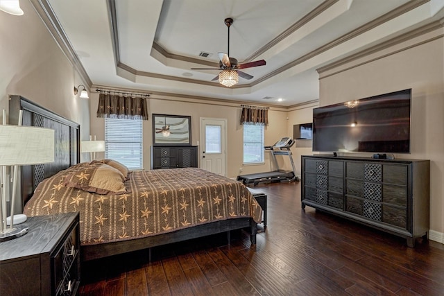 bedroom featuring a raised ceiling, ornamental molding, and hardwood / wood-style flooring