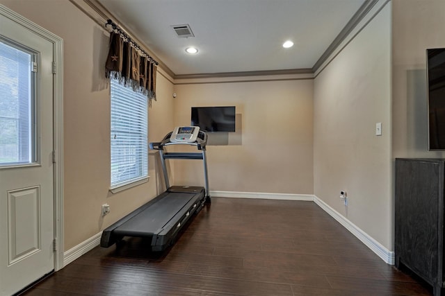 exercise area featuring wood finished floors, baseboards, visible vents, ornamental molding, and recessed lighting