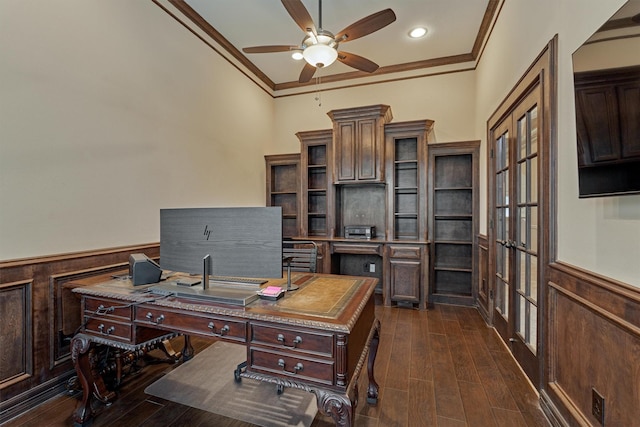 office space featuring french doors, ornamental molding, a wainscoted wall, dark wood-style floors, and a ceiling fan