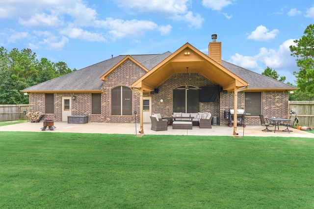back of property featuring an outdoor hangout area, brick siding, fence, and a patio