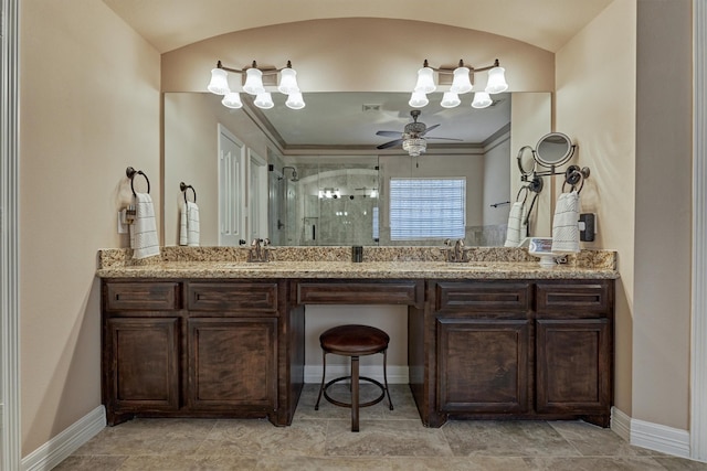 full bath with double vanity, a sink, and a stall shower