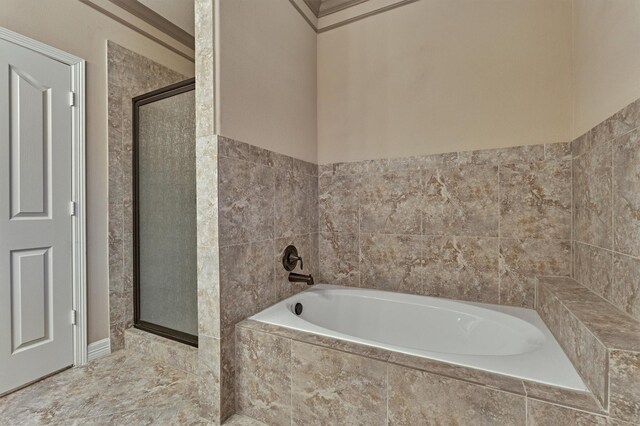 full bathroom featuring a stall shower and a bath