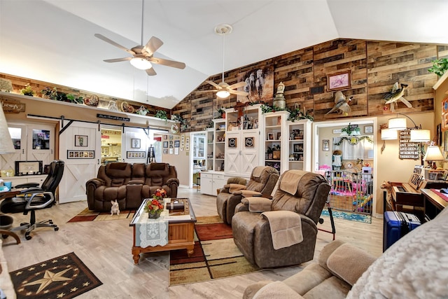 living area featuring high vaulted ceiling, ceiling fan, and wood finished floors