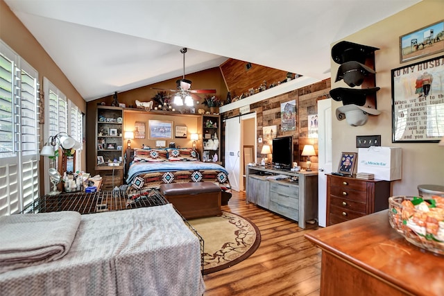 bedroom featuring light wood finished floors and vaulted ceiling