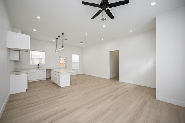 8203 Sparta St Unit B, Houston, TX 77028 - kitchen with a center island, a sink, open floor plan, recessed lighting, and light countertops