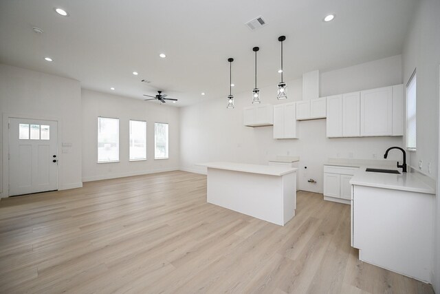 8203 Sparta St Unit B, Houston, TX 77028 - kitchen featuring ceiling fan, light wood-style floors, a sink, and recessed lighting