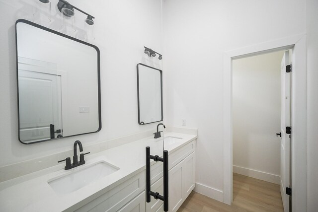 8203 Sparta St Unit B, Houston, TX 77028 - full bathroom featuring baseboards, wood finished floors, a sink, and double vanity