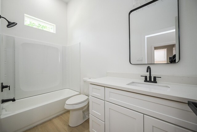 8203 Sparta St Unit B, Houston, TX 77028 - bathroom with toilet, vanity, wood finished floors, and shower / bath combination