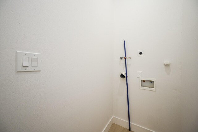 8203 Sparta St Unit B, Houston, TX 77028 - washroom with laundry area, hookup for an electric dryer, light wood-style floors, baseboards, and washer hookup