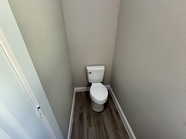 9805 Fabiola Dr, Houston, TX 77075 - bathroom with toilet, a textured wall, wood finished floors, and baseboards