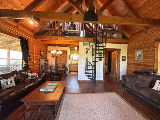living room with wood finished floors, an inviting chandelier, stairway, and beam ceiling