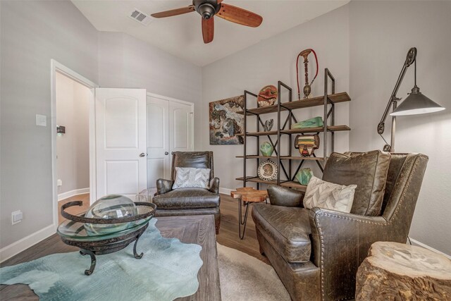 sitting room featuring baseboards, visible vents, wood finished floors, and a ceiling fan