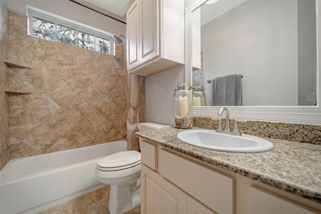 full bathroom featuring toilet, vanity, and tub / shower combination